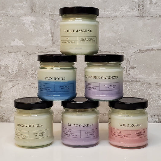 The Floral Collection of Six 3oz Soy Wax Candles including White Jasmine, Patchouli, Lavender Gardens, Lilac Gardens, Honeysuckle, and Wild Roses.